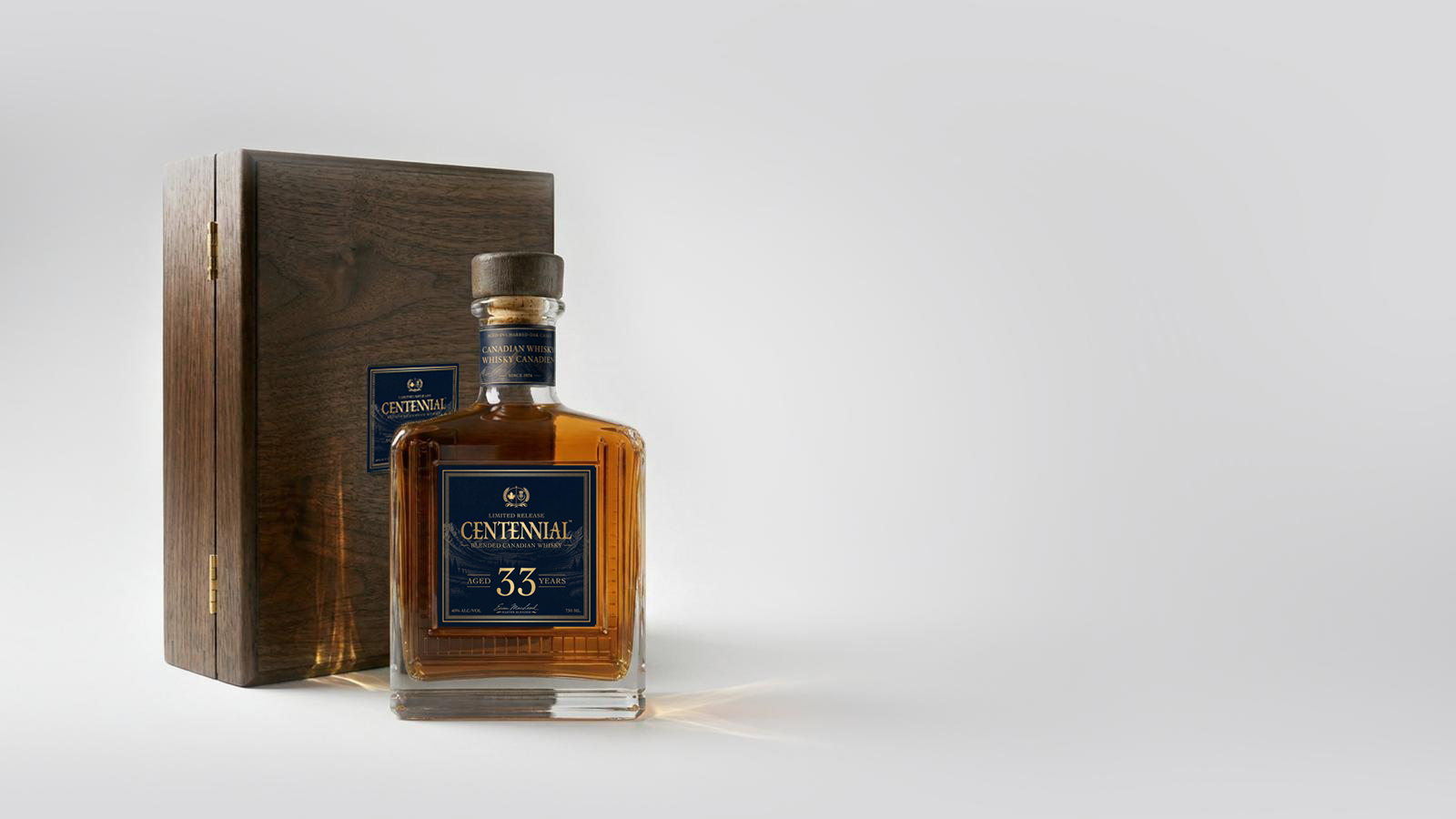 Centennial 33 Year Old whisky bottle alongside its hinged walnut presentation case
